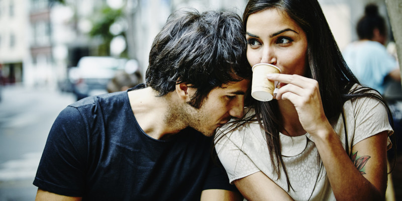 Couple sitting at city cafe drinking espresso