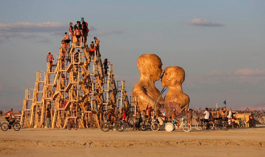 People interact with art installations during the Burning Man 2014 "Caravansary" arts and music festival in the Black Rock Desert of Nevada
