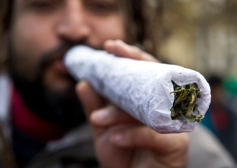 A man holds a giant joint during a march for the legalization of cannabis in Santiago, on May 18, 2013, as part of the 2013 Global Marijuana March which is being held in hundreds of cities worldwide. AFP PHOTO / Martin BERNETTI (Photo credit should read MARTIN BERNETTI/AFP/Getty Images)