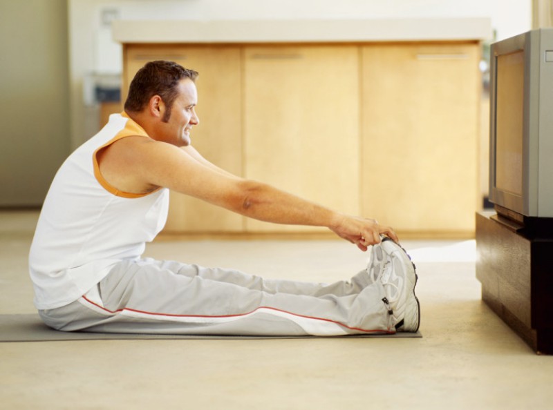 side profile of a mid adult man exercising on the floor --- Image by © Royalty-Free/Corbis