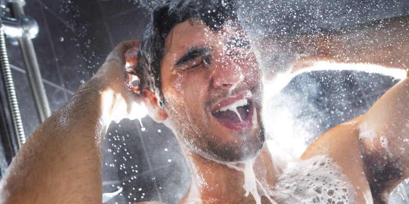 Man in shower, rinsing shampoo from hair