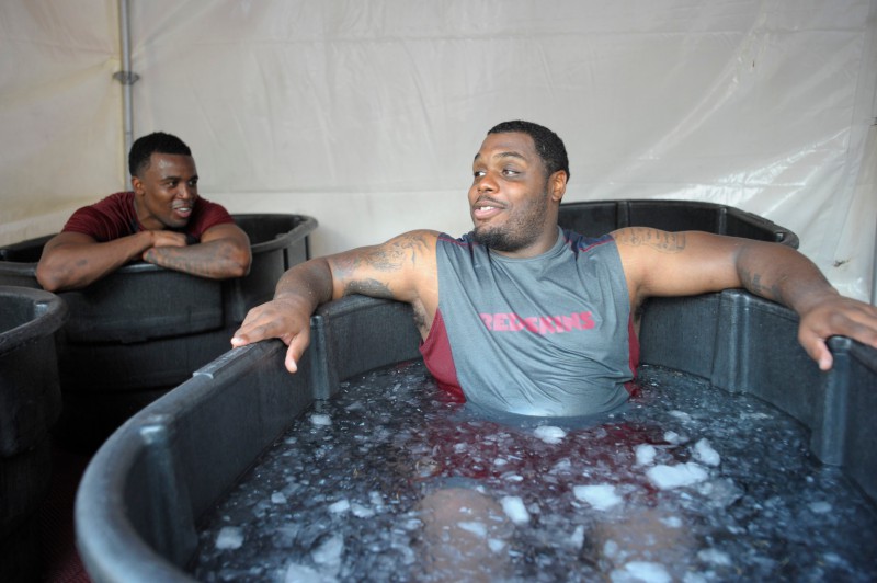 ASHBURN VA JULY 26: Washington Redskins' rookie Wide receiver Darius Hanks , left, talks with Defensive lineman Chris Baker, right, as they sit in tub of ice cooling off after the 1st day of training camp at Redskins Park in Ashburn VA July 26 2012 (Photo by John McDonnell/The Washington Post via Getty Images)