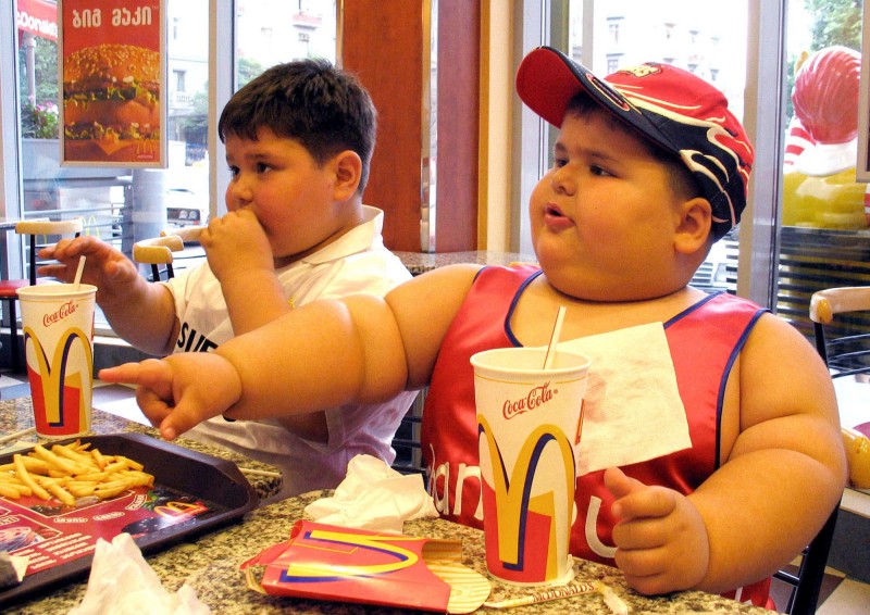 TT-BARNFETMA (ARKIV) ** FILE ** Dzhambulat Khotokhov, right, a 4-year-old Russian weighing 56 kilograms (123 pounds) with a height of 118 centimeters (3 feet 11 inches), and Georgy Bibilauri, a Georgian, who turned 5 on Wednesday, 120 centimeters (4 feet) tall and weighs 51 kilograms (112 pounds), enjoy a meal at a McDonald's restaurant, in Tbilisi, Georgia in this Wednesday, July 9, 2003 file photo. Fast food giant McDonald's is to phase out it's supersize portions it announced Wednesday March 3, 2004, although it claimed that the supersize category represented a tiny portion of its business. (AP Photo/ Shakh Aivazov ) COPYRIGHT SCANPIX SWEDEN Code: 436